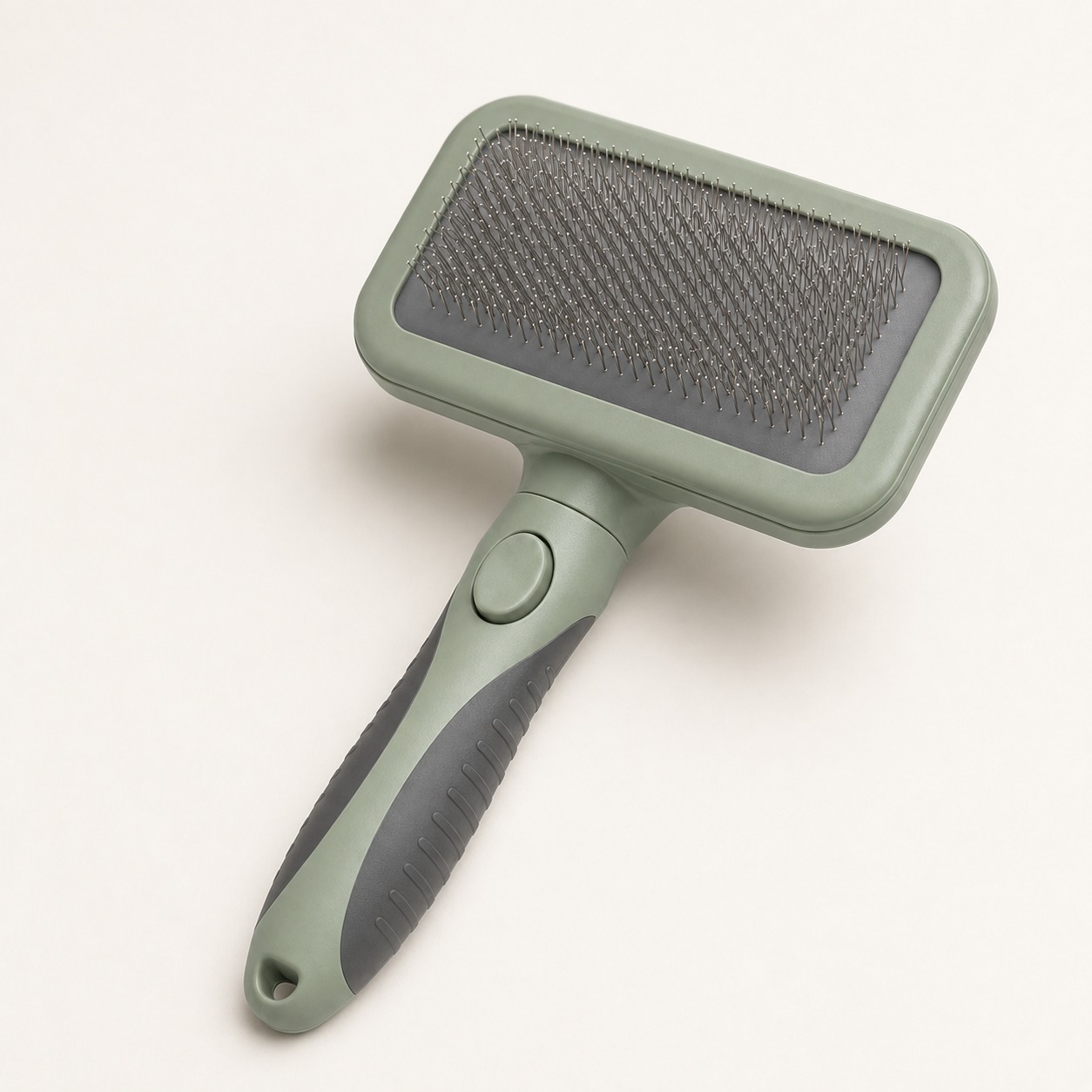 Close-up of self-cleaning pet slicker brush pins button and handle